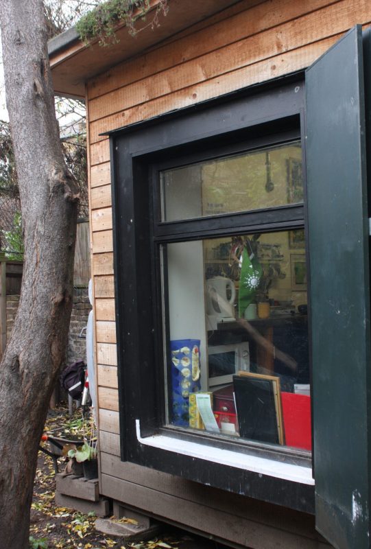 image showing a sustainable shed near a tree