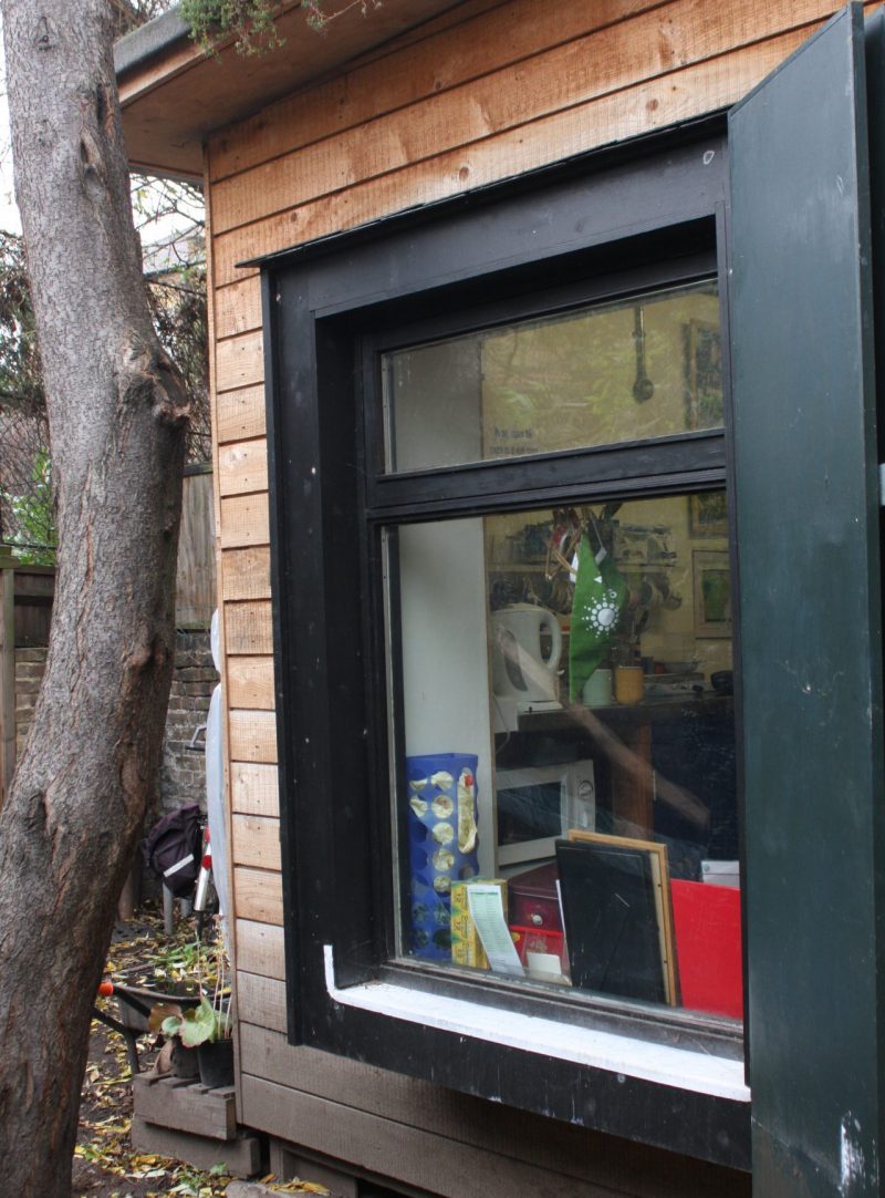 image showing a sustainable shed near a tree