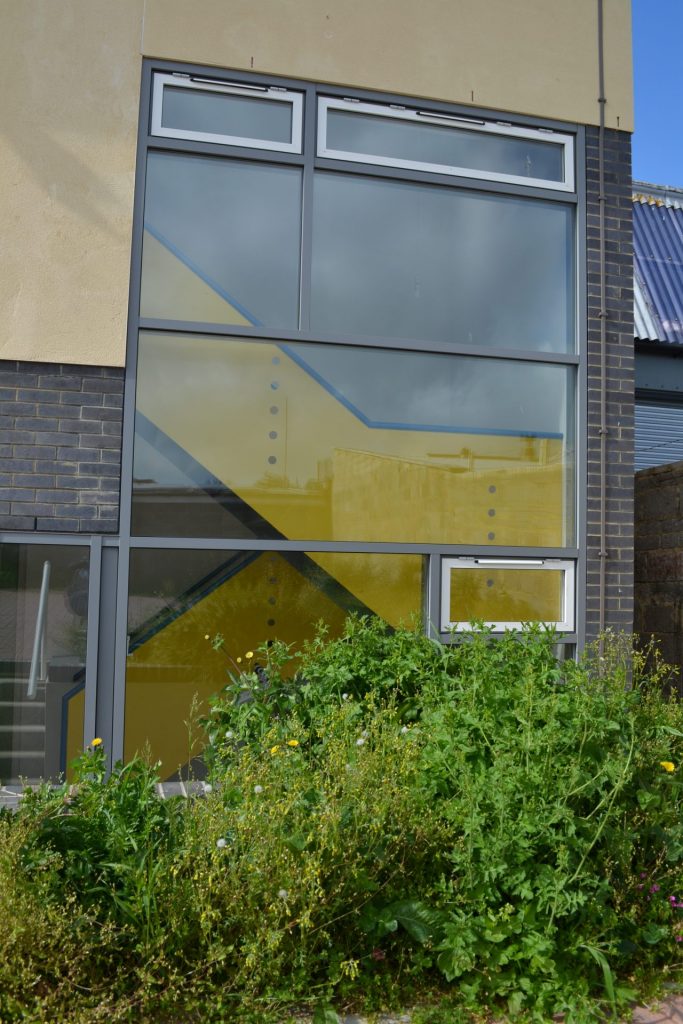 Exterior facade of community centre showing yellow metal balustrading