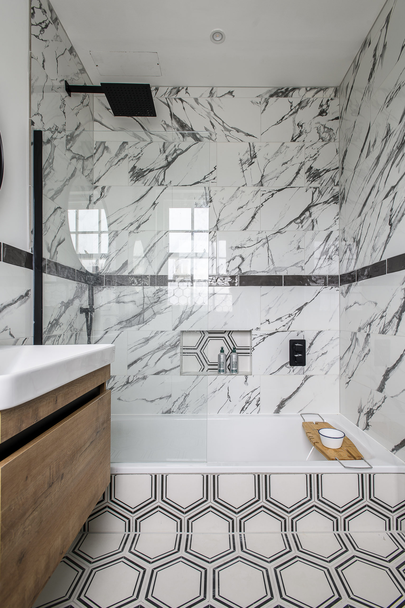 Brighton Interior Design Contemporary bathroom design with marble-effect wall tiles, geometric floor tiles, bespoke vanity unit and frameless glass shower screen by Shape Architecture.