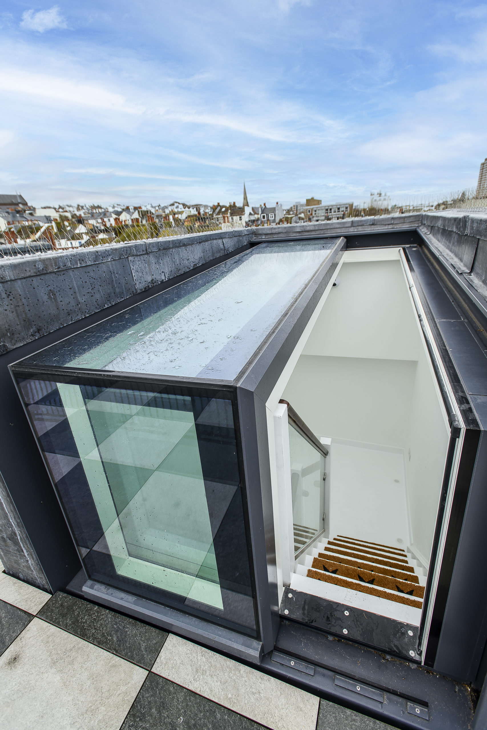 Roof Terrace Brighton roof terrace with glazed stair access box, tiled terrace surface and surrounding parapet walls designed by Shape Architecture.