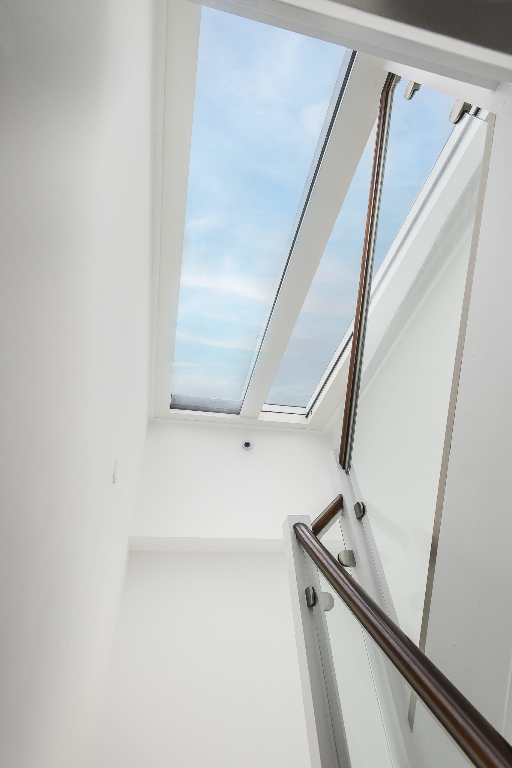 Stair to Roof Terrace Internal stair viewed through a large rooflight, allowing natural daylight to flood the stairwell in a contemporary residential project.