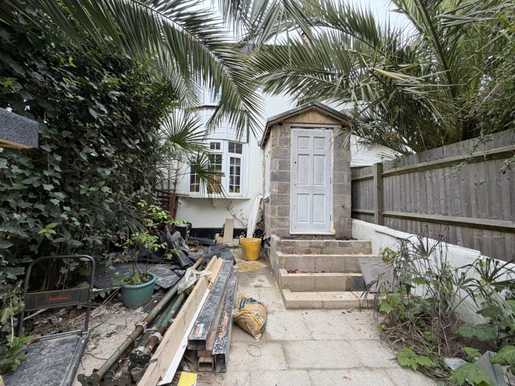 Wide view of proposed rear extension and garden setting in Brighton, showing new outbuilding within landscaped context.